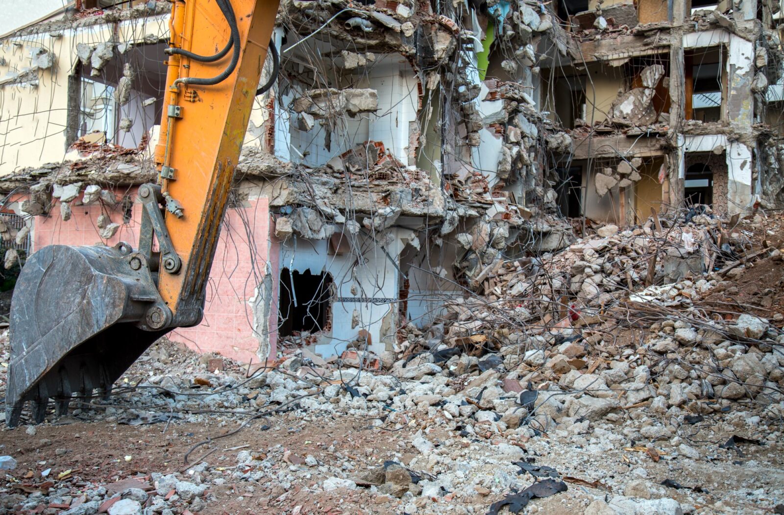 House being demolished by an excavator